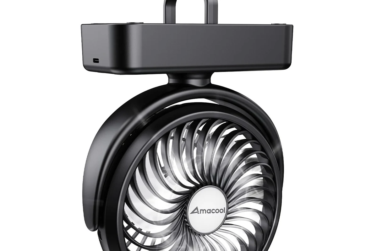 Compact clip-on camper bunk fan mounted beside an RV bed for personal cooling