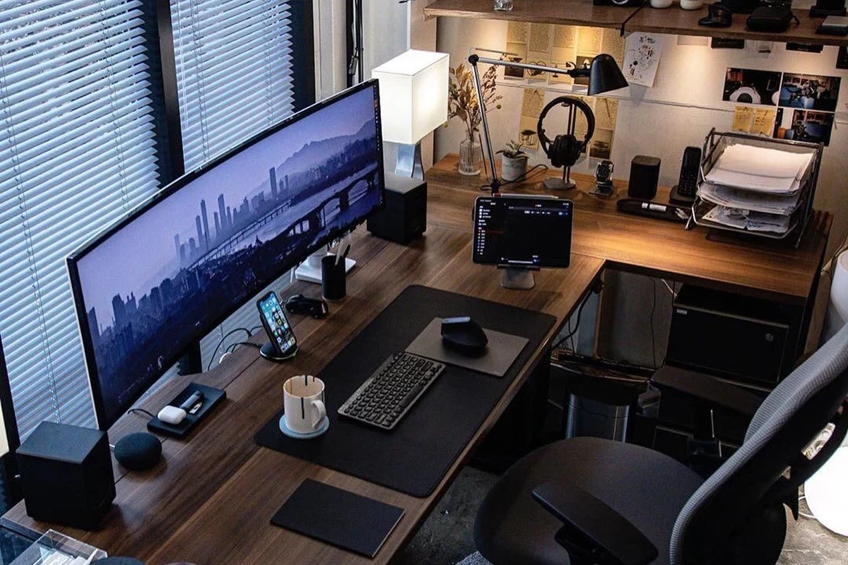Compact ultra-quiet desk fan on a home office desk beside a laptop and notebook
