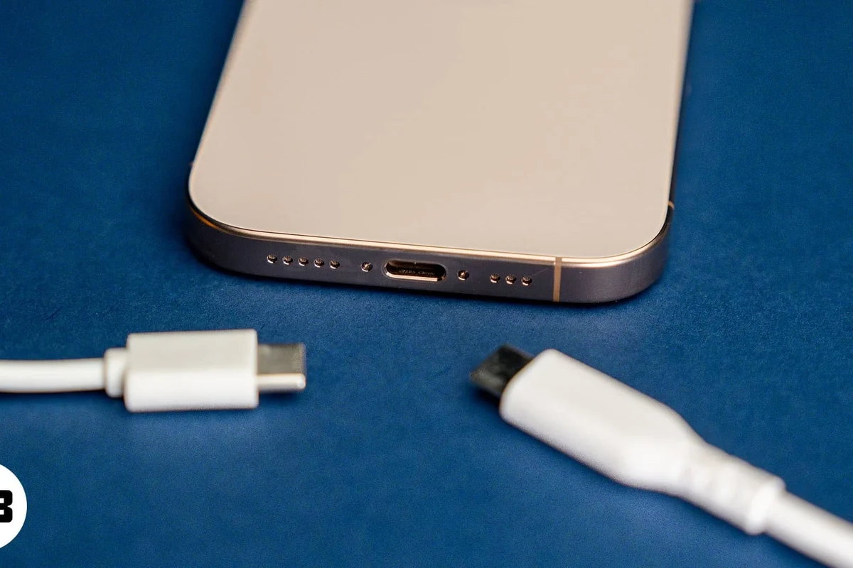 iPhone 14 Pro Max wallet case with MagSafe on a desk beside cards and a charger
