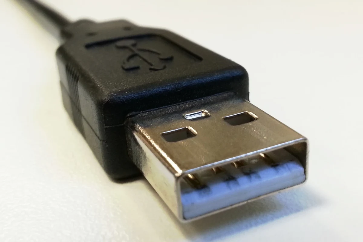 Wireless charging pad powering a smartphone on a desk with a clean modern setup