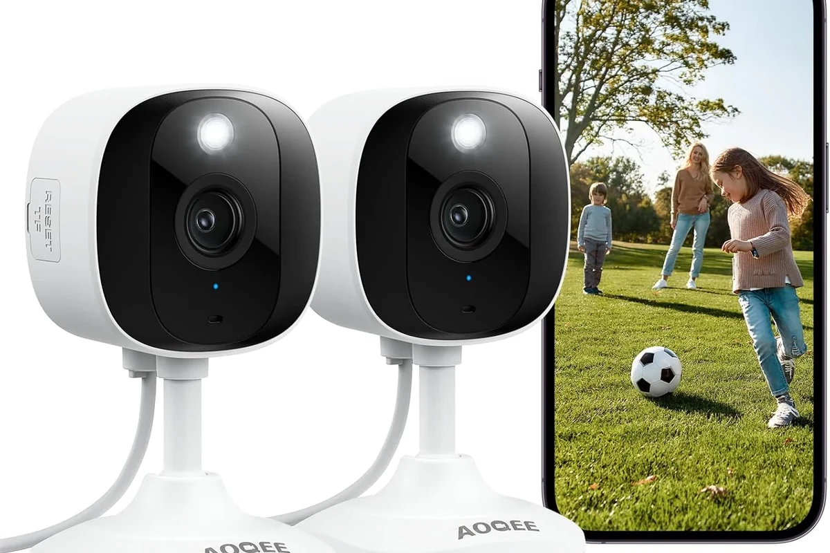 Aoqee security camera mounted indoors for smart home monitoring with a phone app nearby