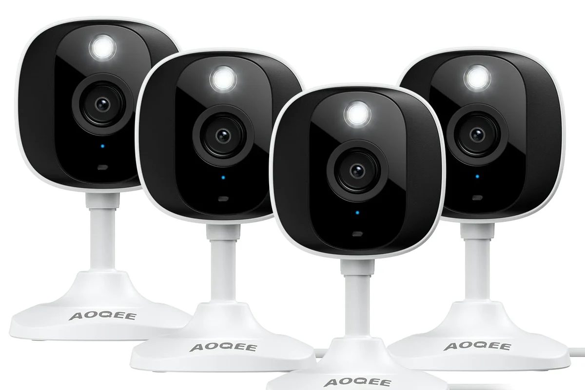 Aoqee security camera mounted indoors for smart home monitoring with a phone app nearby