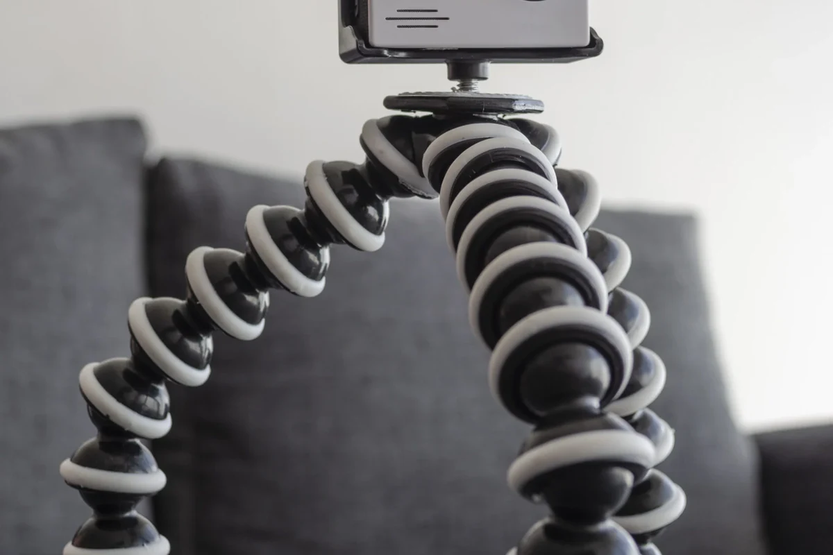 Crossword grid beside a camera lens and accessory on a desk