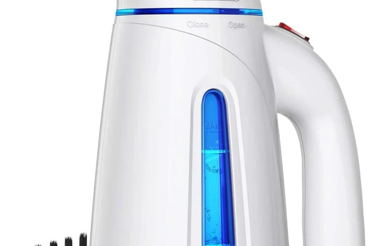 Steam press appliance smoothing a shirt on a large heated pressing surface in a home laundry room