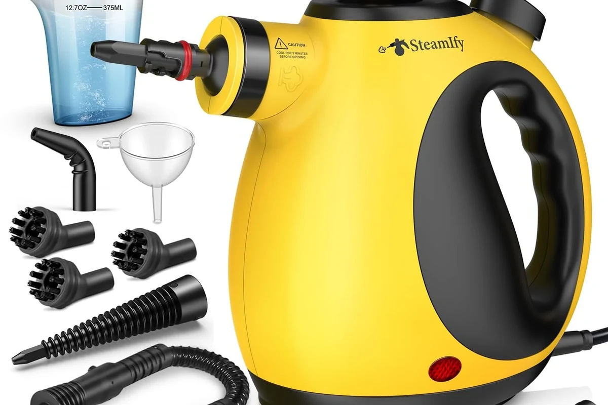 Steam cleaner brush cleaning grout lines on a tiled bathroom floor