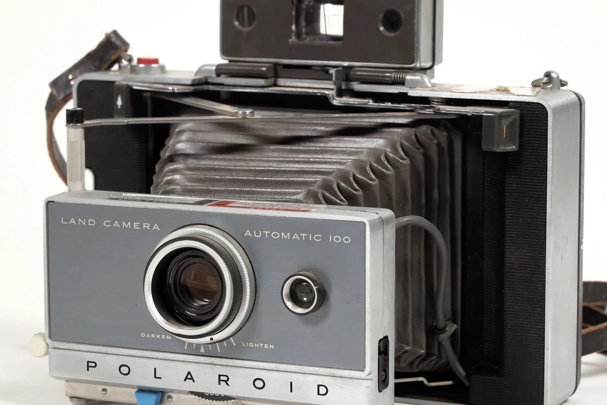Vintage Polaroid Land Camera Automatic 100 folding instant camera on a clean tabletop