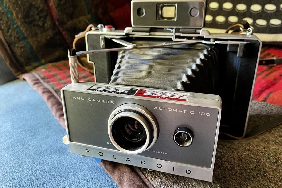 Vintage Polaroid Land Camera Automatic 100 folding instant camera on a clean tabletop