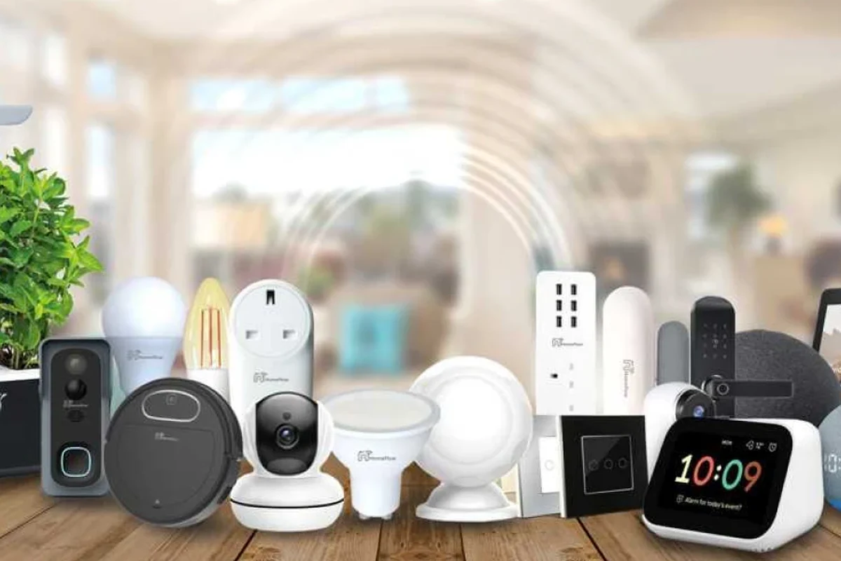 Person cleaning a smart home security camera mounted outdoors near a house