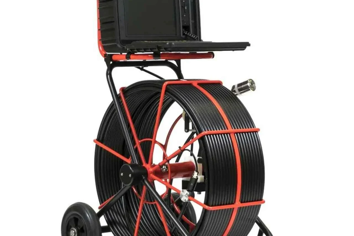 Technician inspecting a sewer pipe with a waterproof camera on a monitor