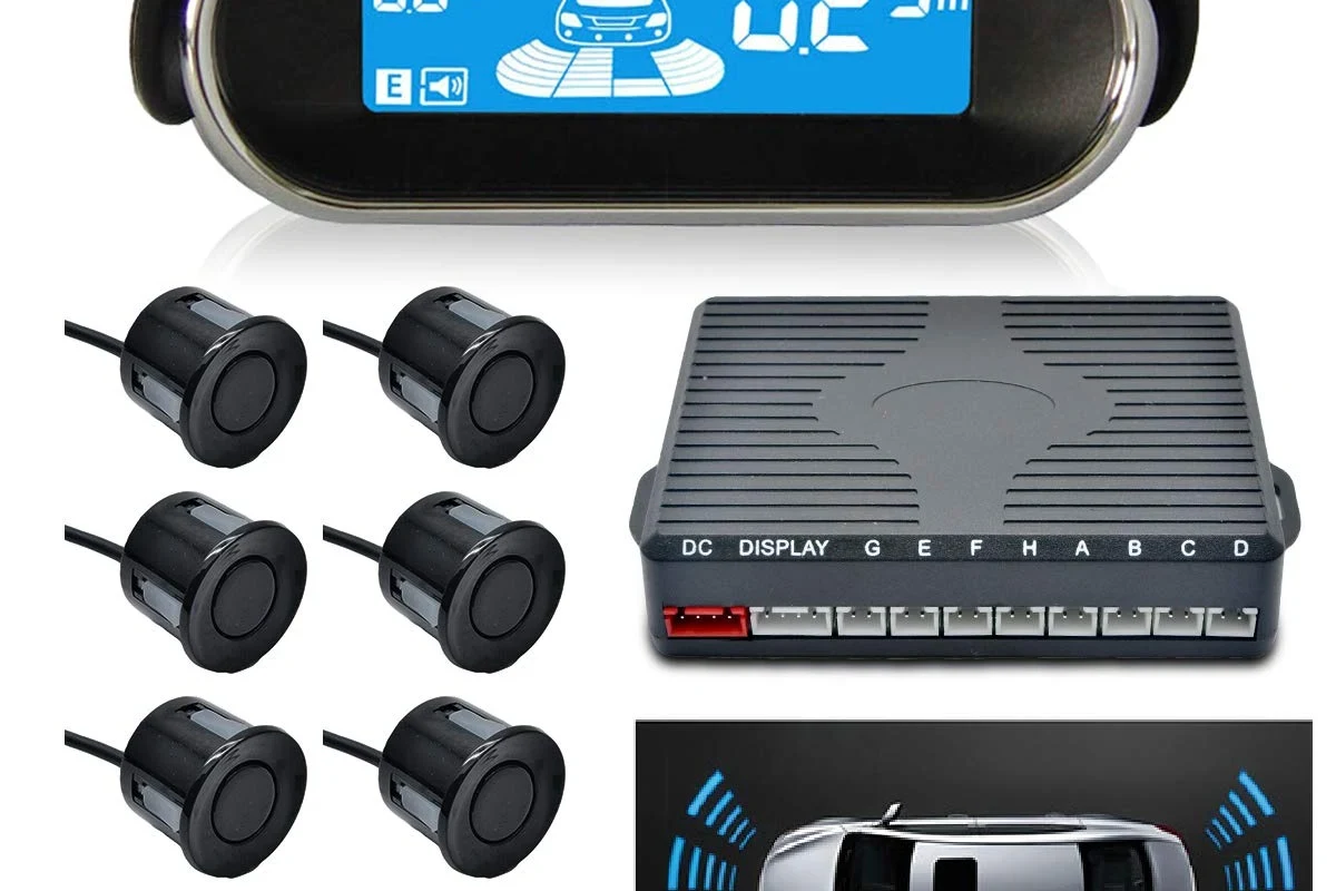 Aftermarket vehicle sensor replacement parts beside OEM-style connectors on a workbench