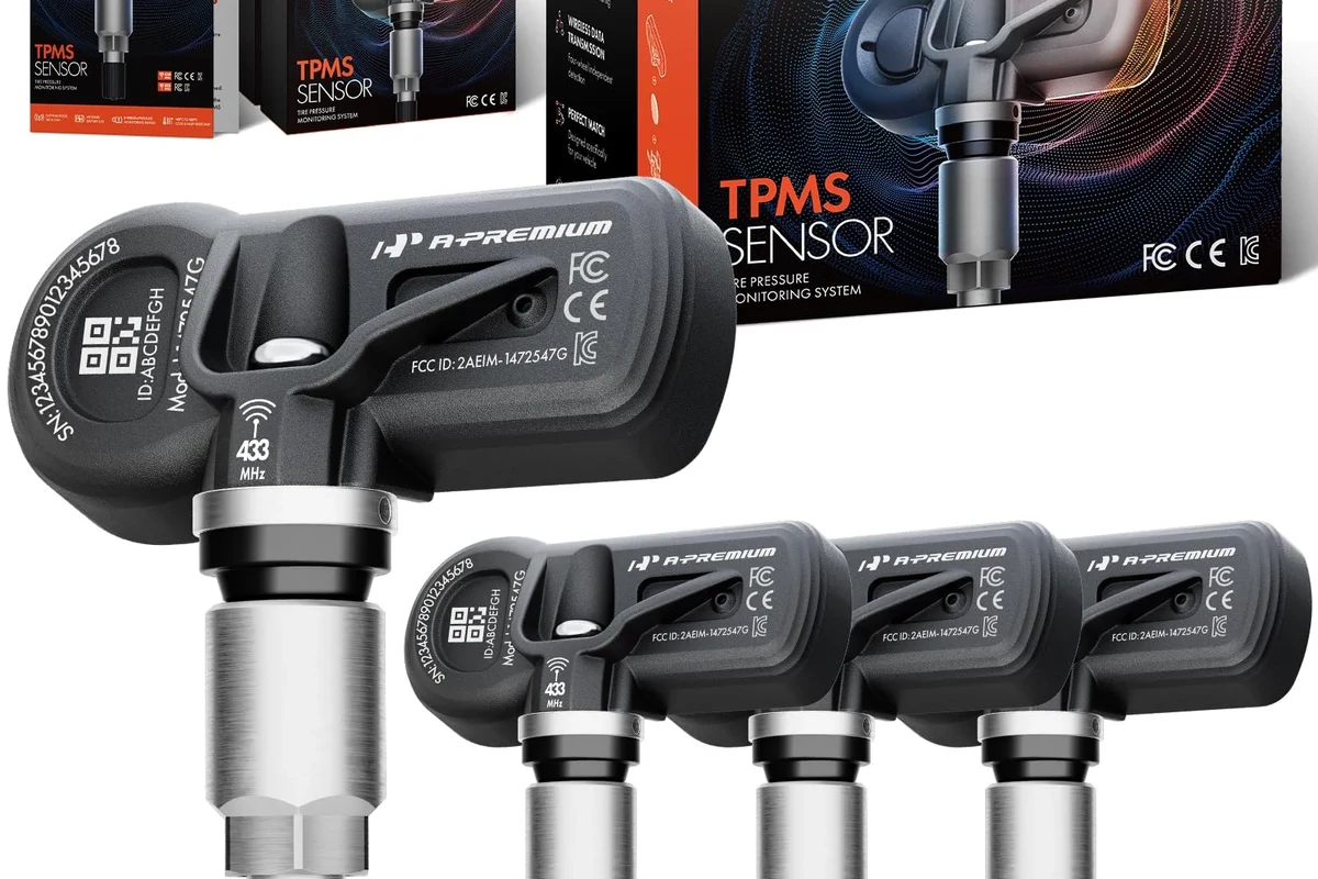 Aftermarket vehicle sensor replacement parts beside OEM-style connectors on a workbench