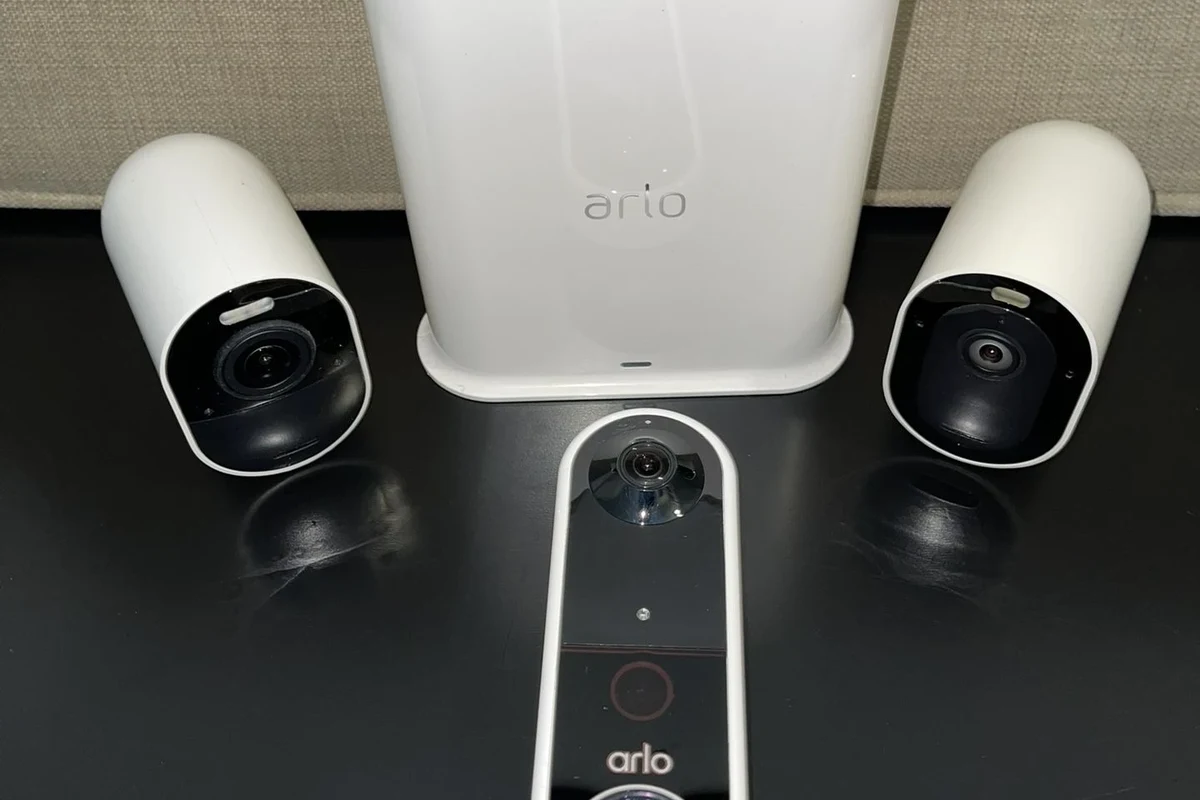 Arlo video doorbell mounted near a home entry with a smart hub nearby