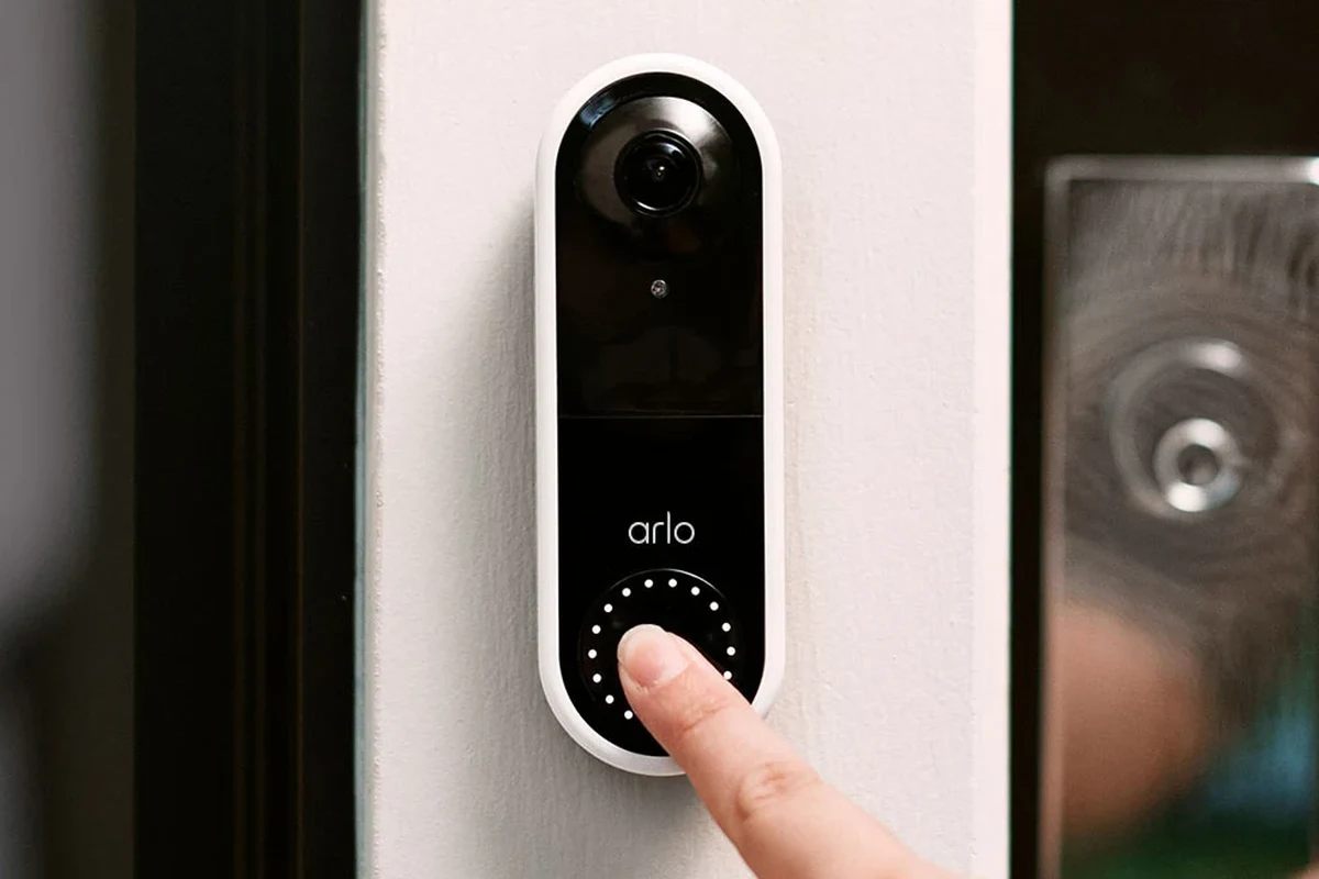 Arlo video doorbell mounted on a home exterior with wiring and battery setup context