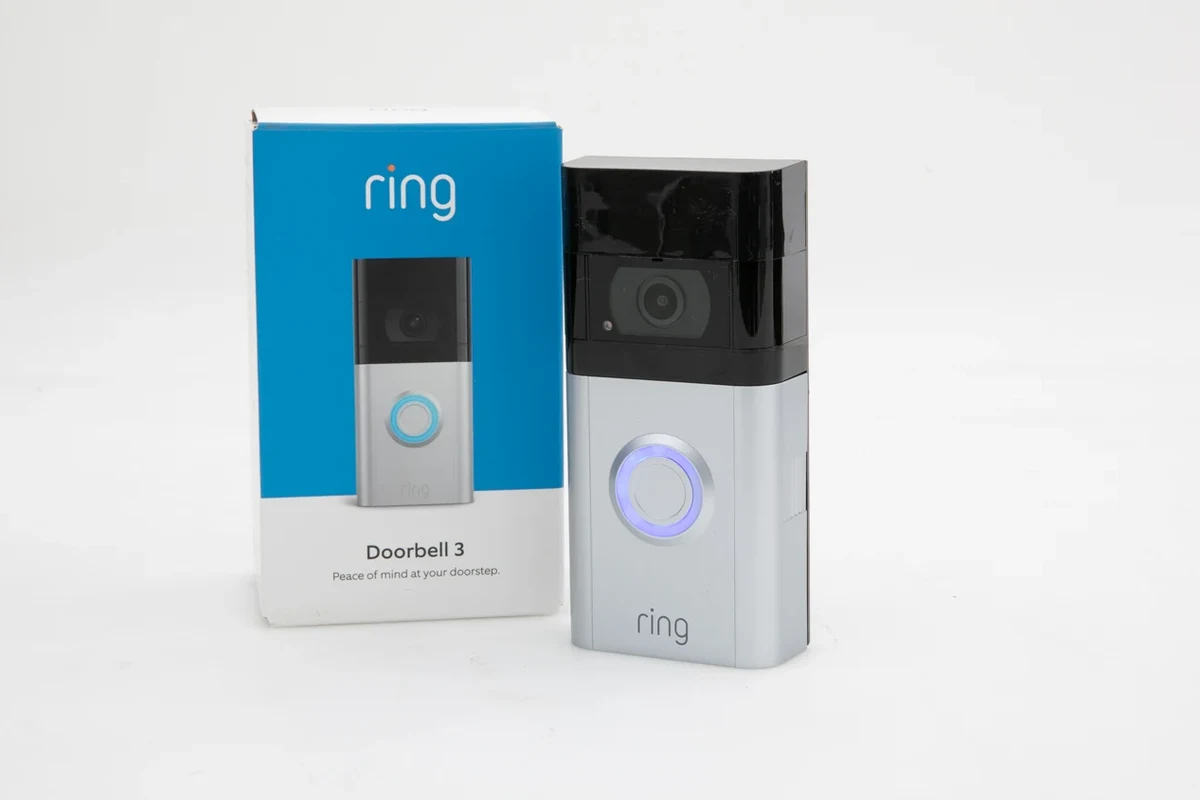 Ring video doorbell displayed near a home entryway with a smartphone app