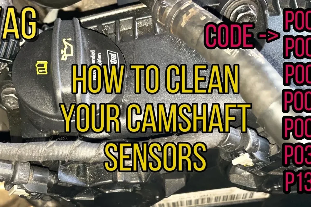 Mechanic inspecting a camshaft position sensor connector near an engine valve cover