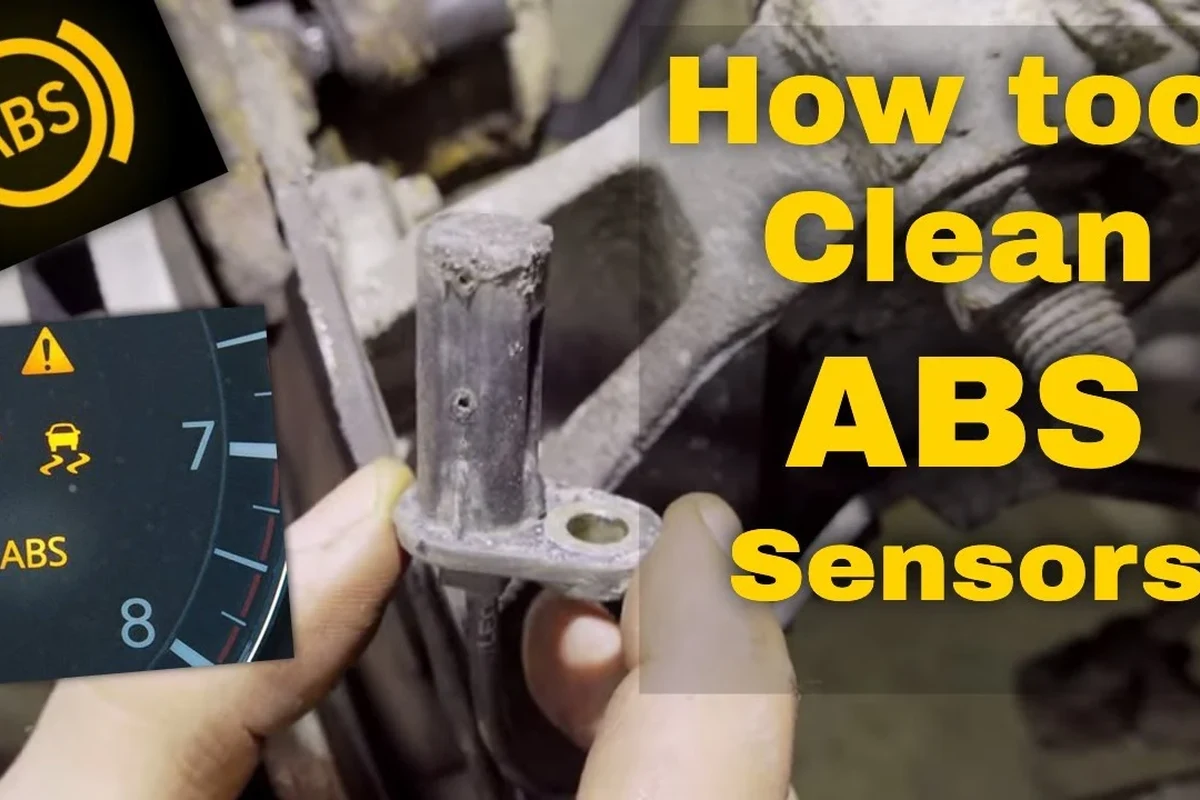 Mechanic inspecting and cleaning a vehicle speed sensor near a transmission housing