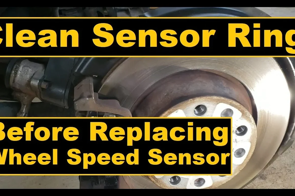 Mechanic inspecting and cleaning a vehicle speed sensor near a transmission housing