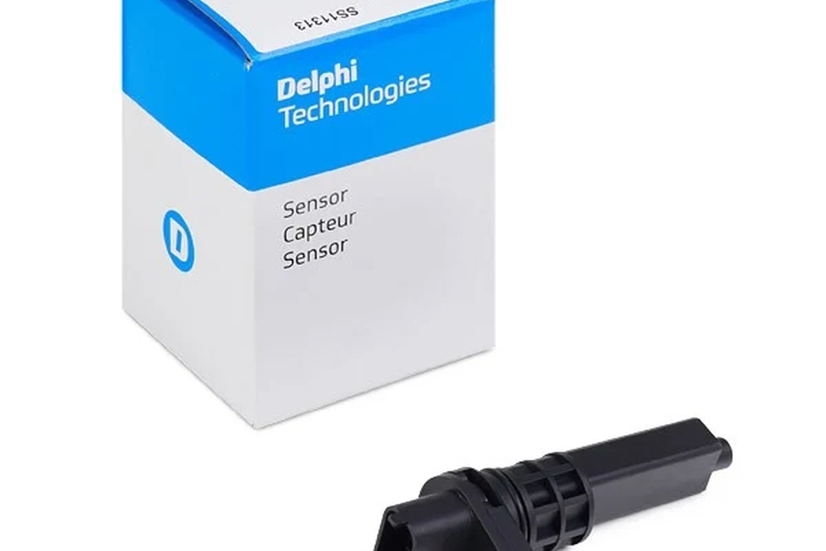 Delphi automotive sensor on a workbench beside wiring connectors and repair tools
