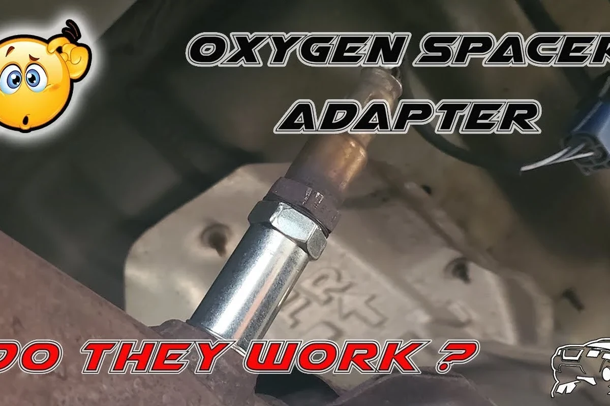 O2 sensor spacer installed on an exhaust sensor bung beneath a vehicle