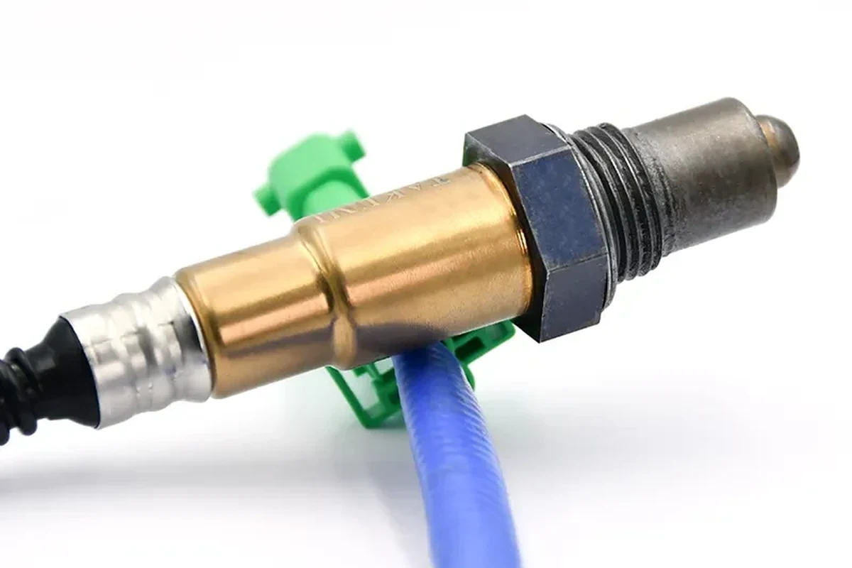 Mechanic-style close-up of an oxygen sensor and exhaust connector on a car
