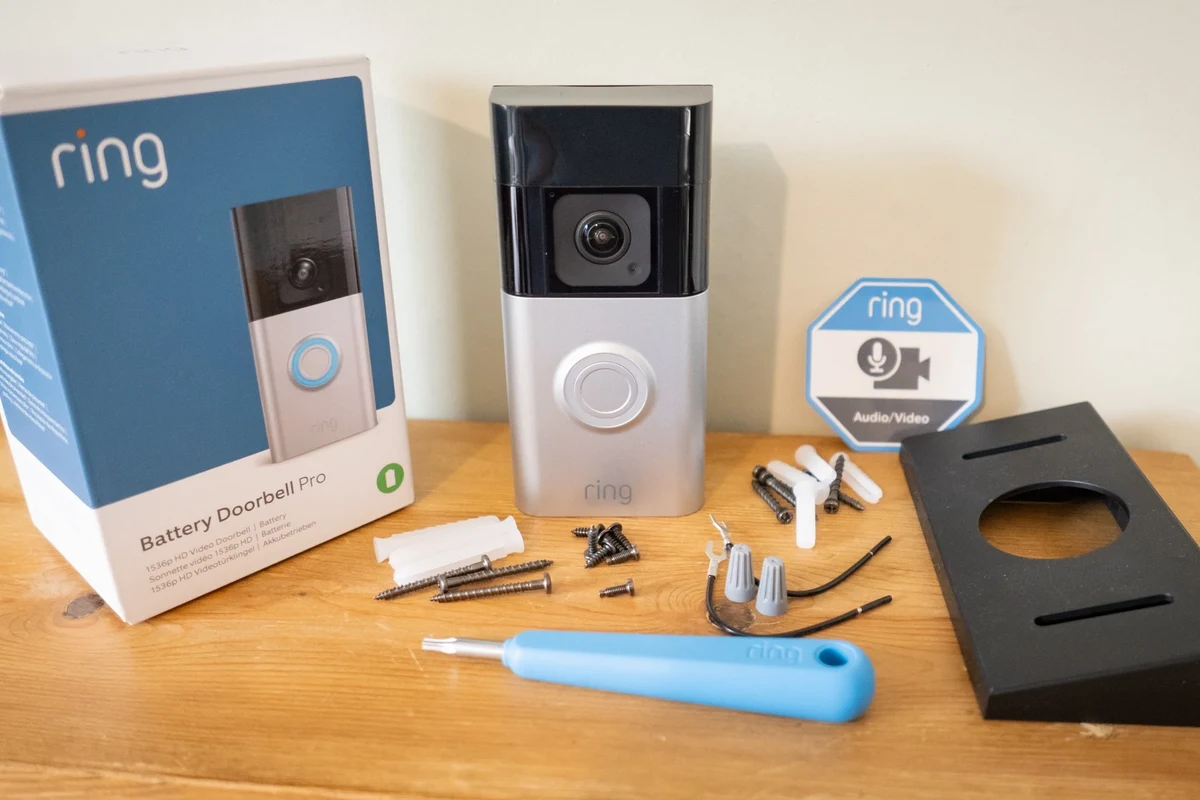 Battery-operated Ring video doorbell mounted beside a front door with app-based smart home setup