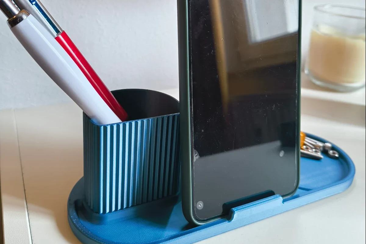 Compact USB-C iPhone charger beside a charging cable and travel pouch on a clean desk