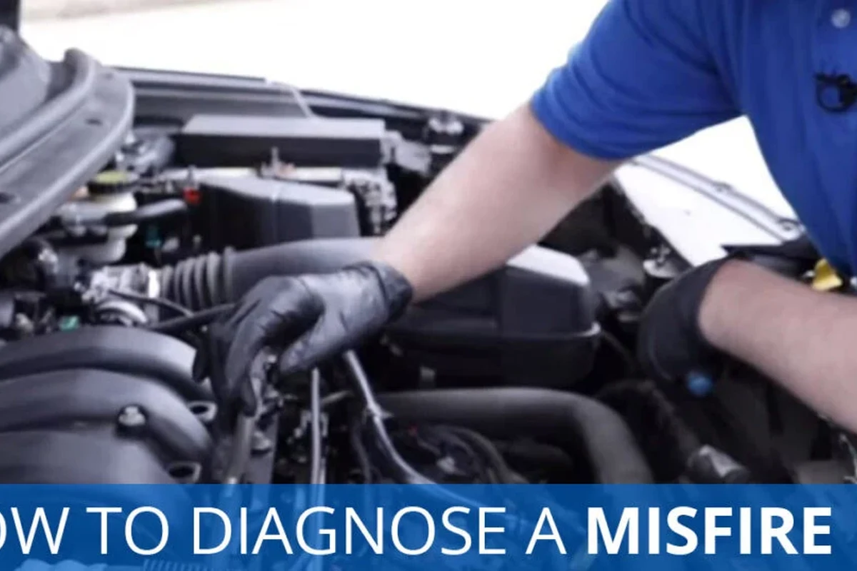 Car engine sensor diagnostic inspection with wiring and scan tool on a workshop bench
