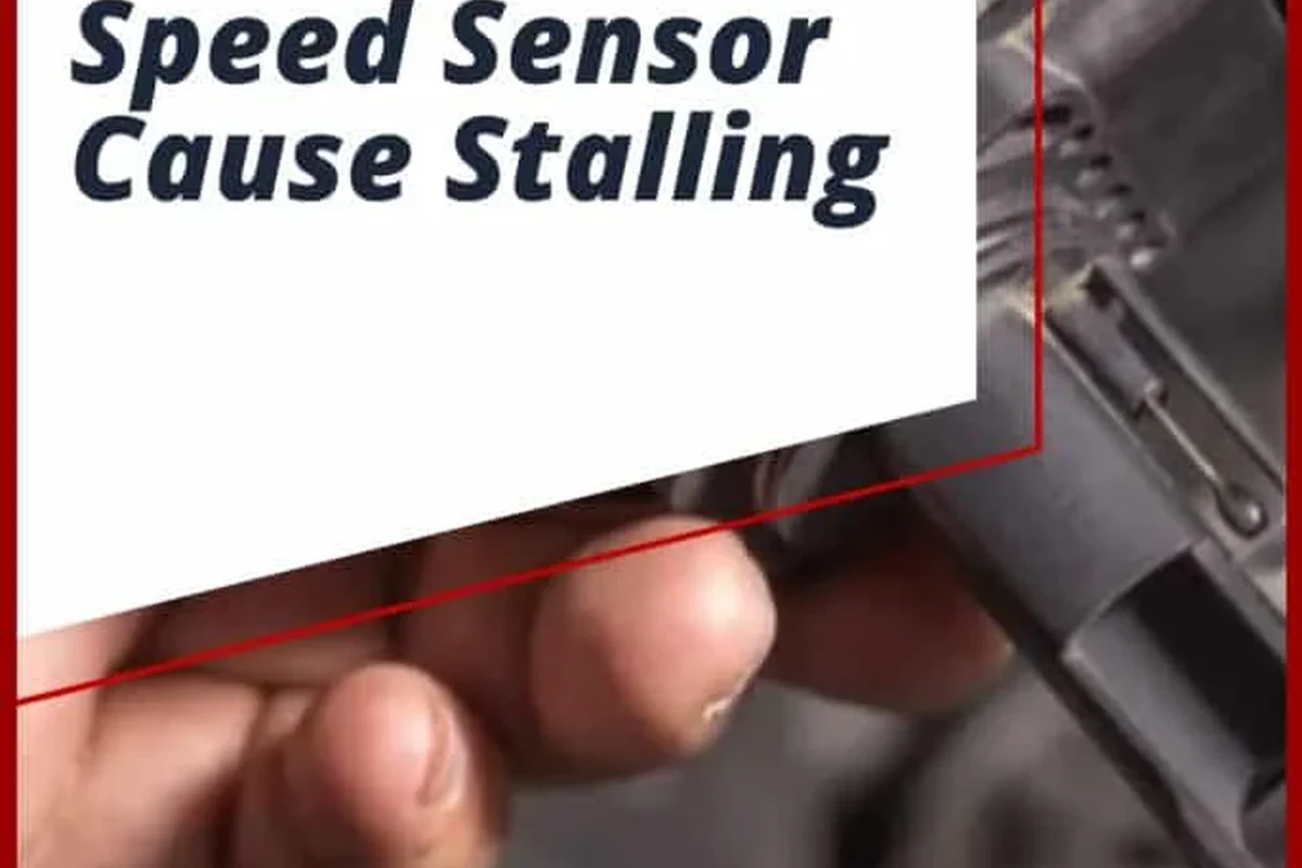 Mechanic inspecting a vehicle speed sensor and wiring near a transmission