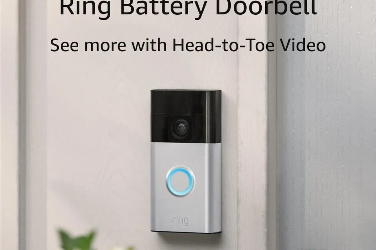 Battery-powered video doorbell mounted beside a front door with a smartphone app nearby