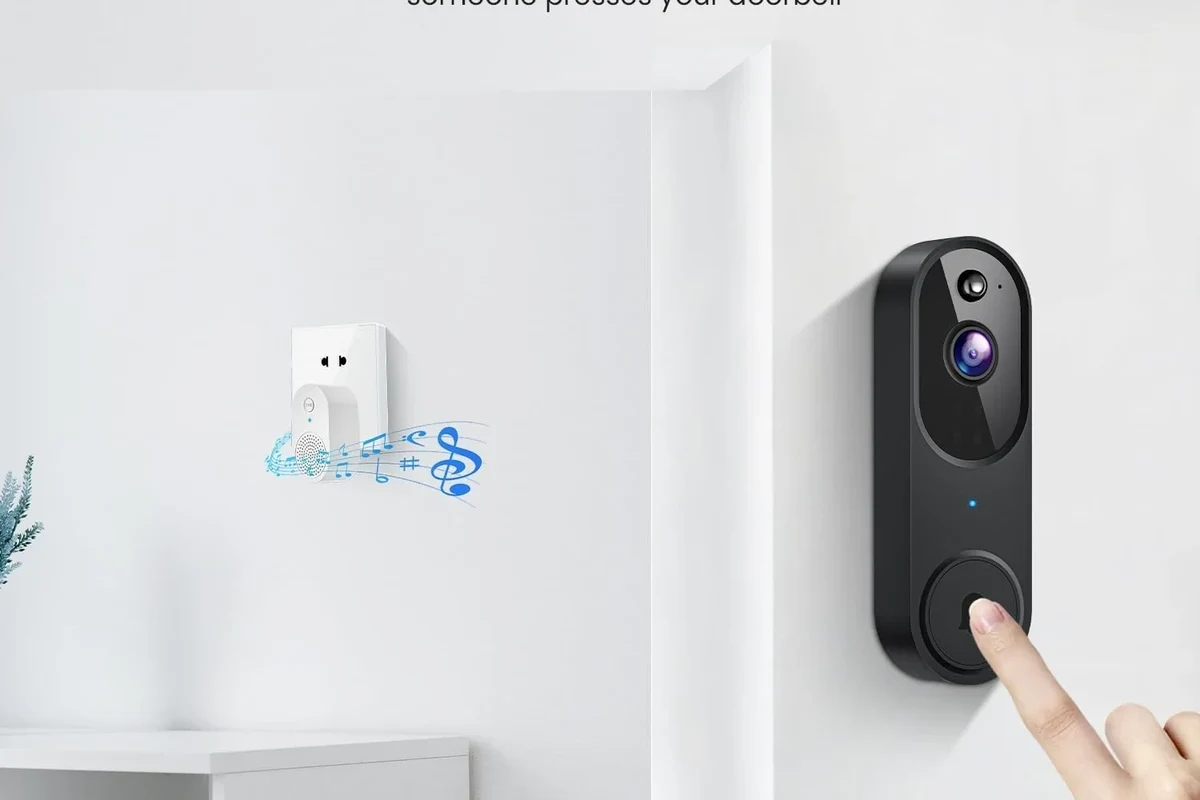 Wireless video doorbell mounted on a front door with a smartphone showing live security alerts