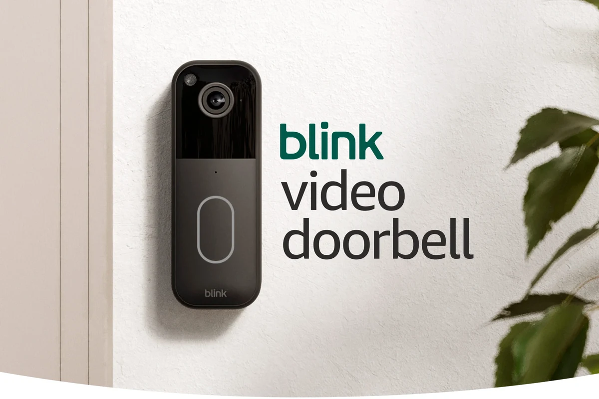 Wireless video doorbell mounted on a front door with a smartphone showing live security alerts