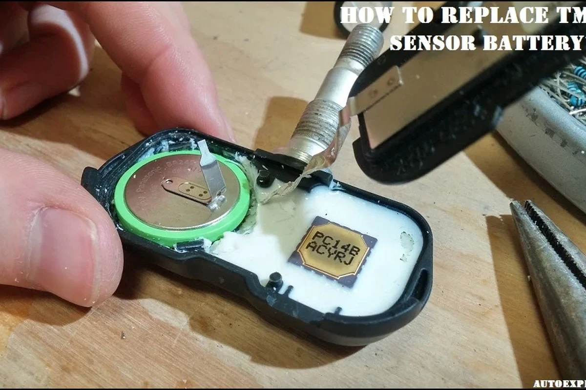 Mechanic-style view of a tire pressure sensor near a wheel and valve stem