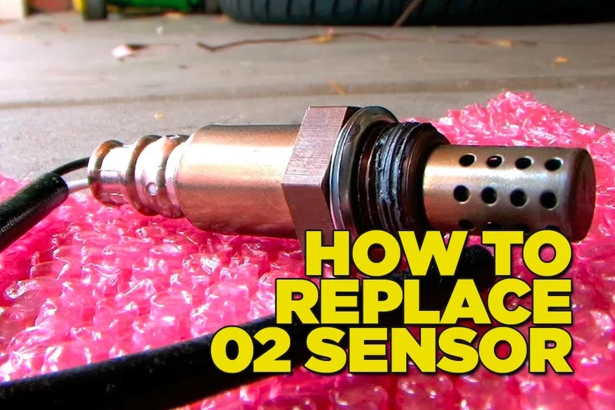 Mechanic-style view of an oxygen sensor on an exhaust system with tools nearby