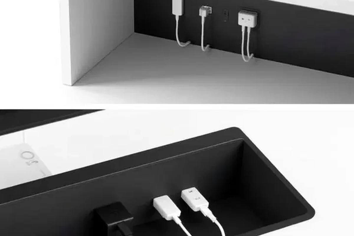 USB-C charging cable connected to a charger beside a laptop and phone