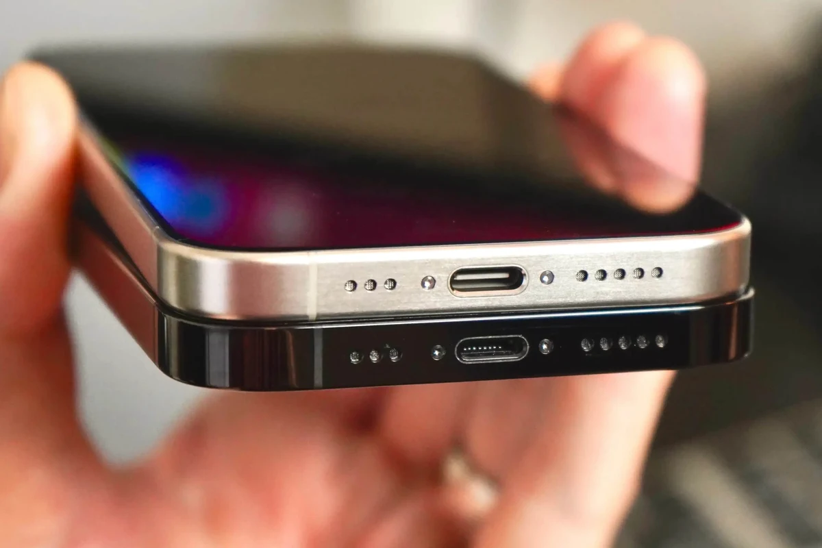 USB-C phone charger and cable beside a smartphone on a clean desk