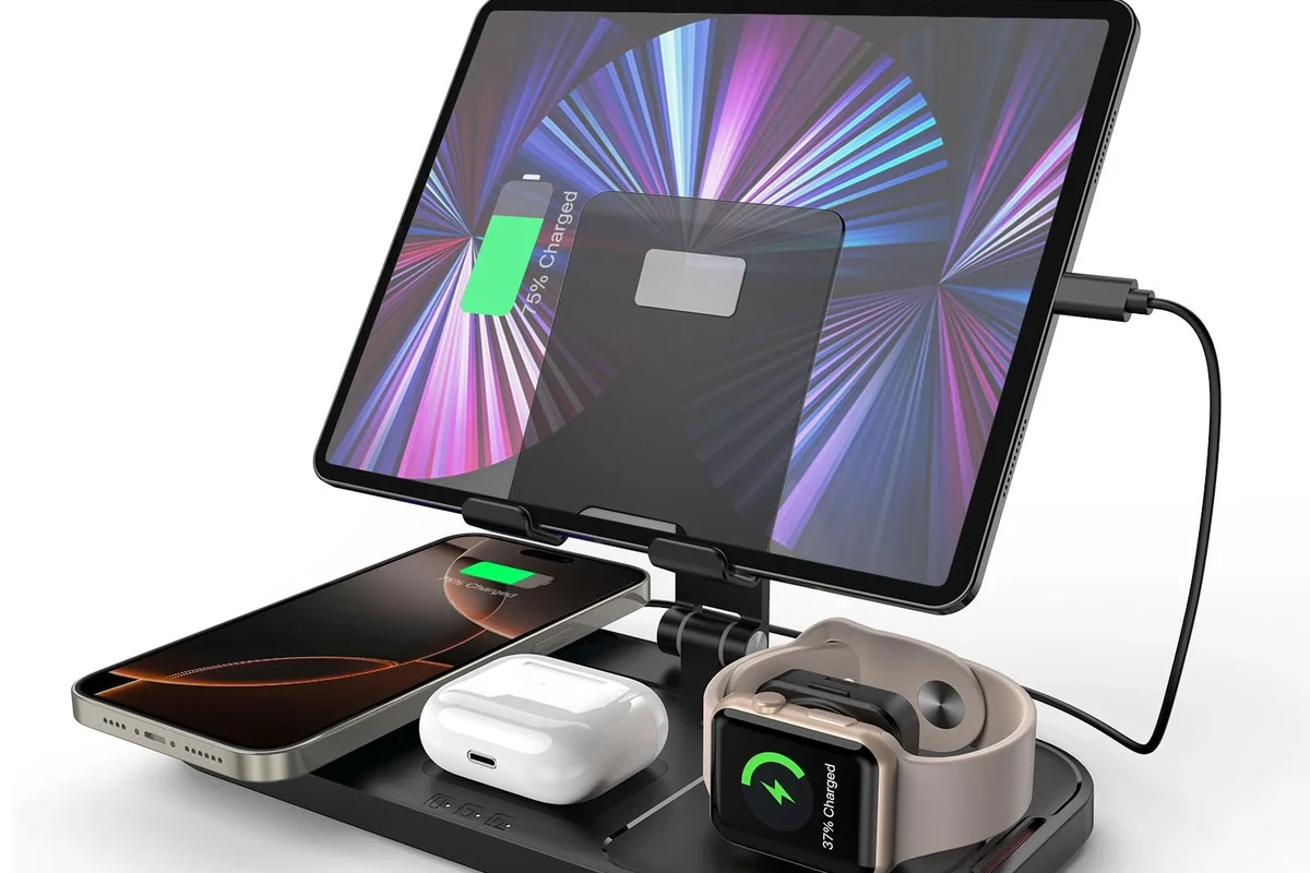 Smartphone charging cable and wireless charger beside a modern phone on a clean desk