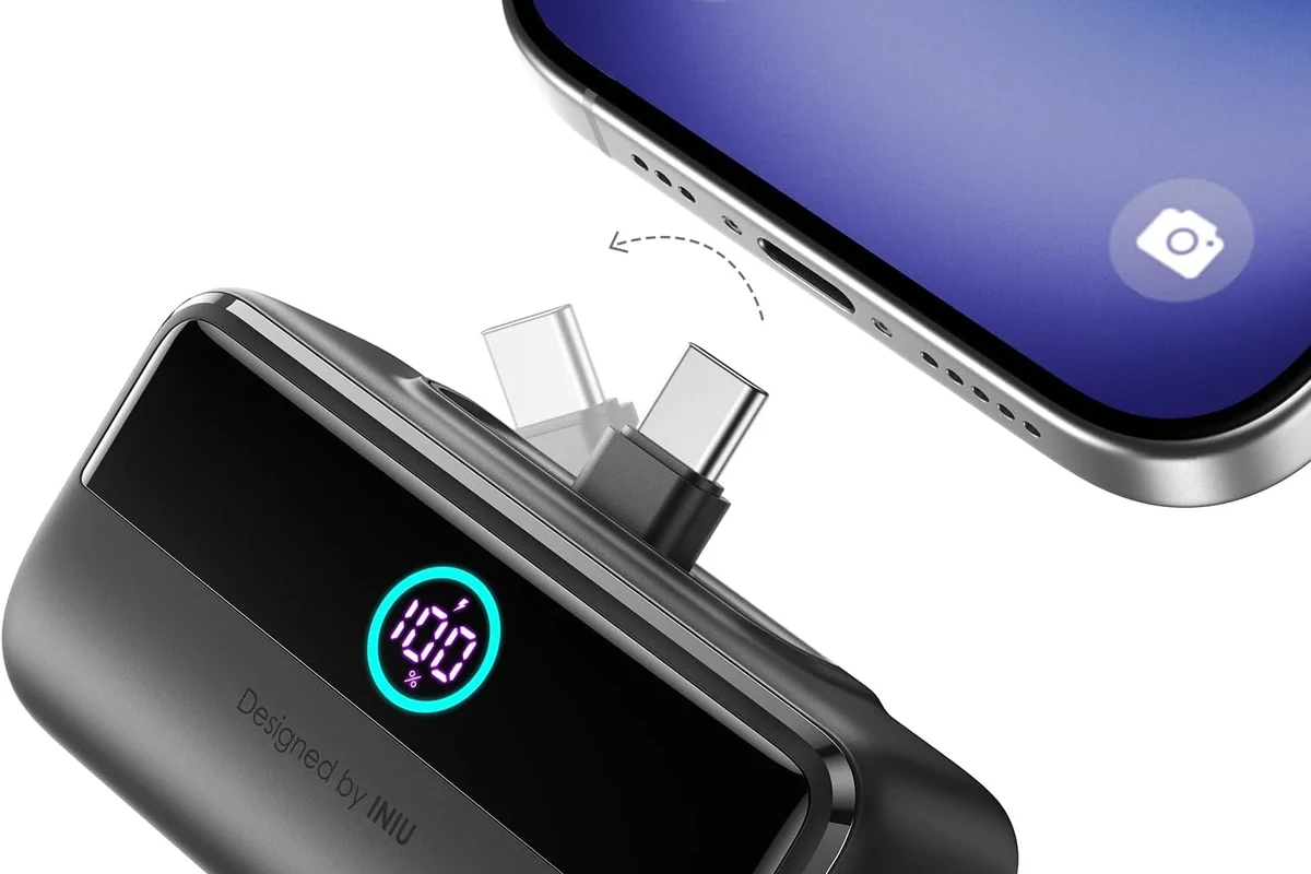 USB-C charging cable beside a laptop, charger, and dock on a clean desk setup
