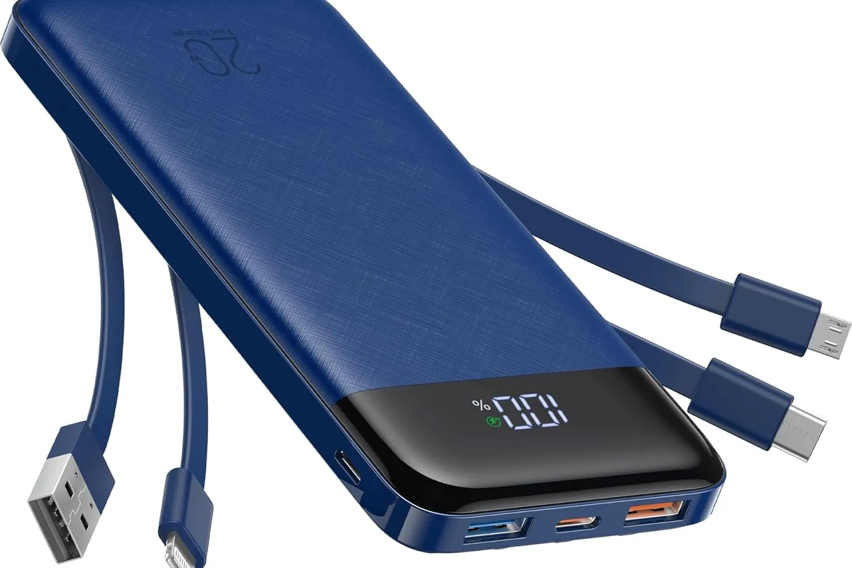 USB-C cables with different thicknesses beside a charger and phone on a desk