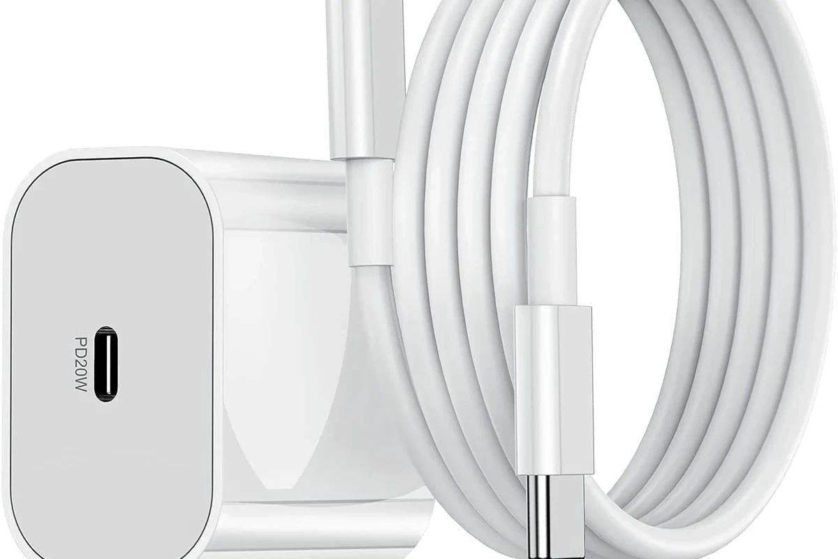 USB-C charging cables arranged beside a phone, tablet, laptop charger, and power bank on a desk