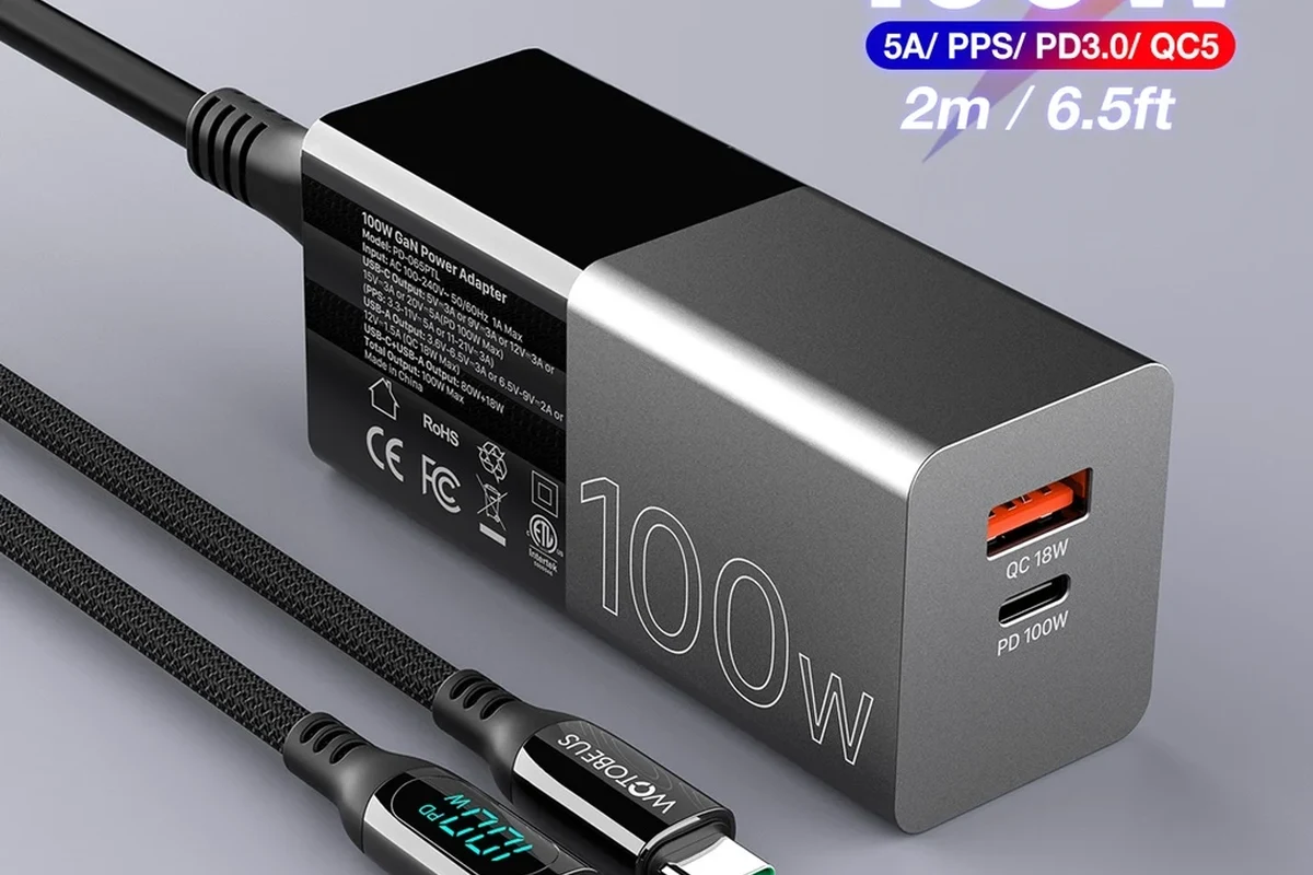 USB-C cable connected to a laptop for charging on a clean desk