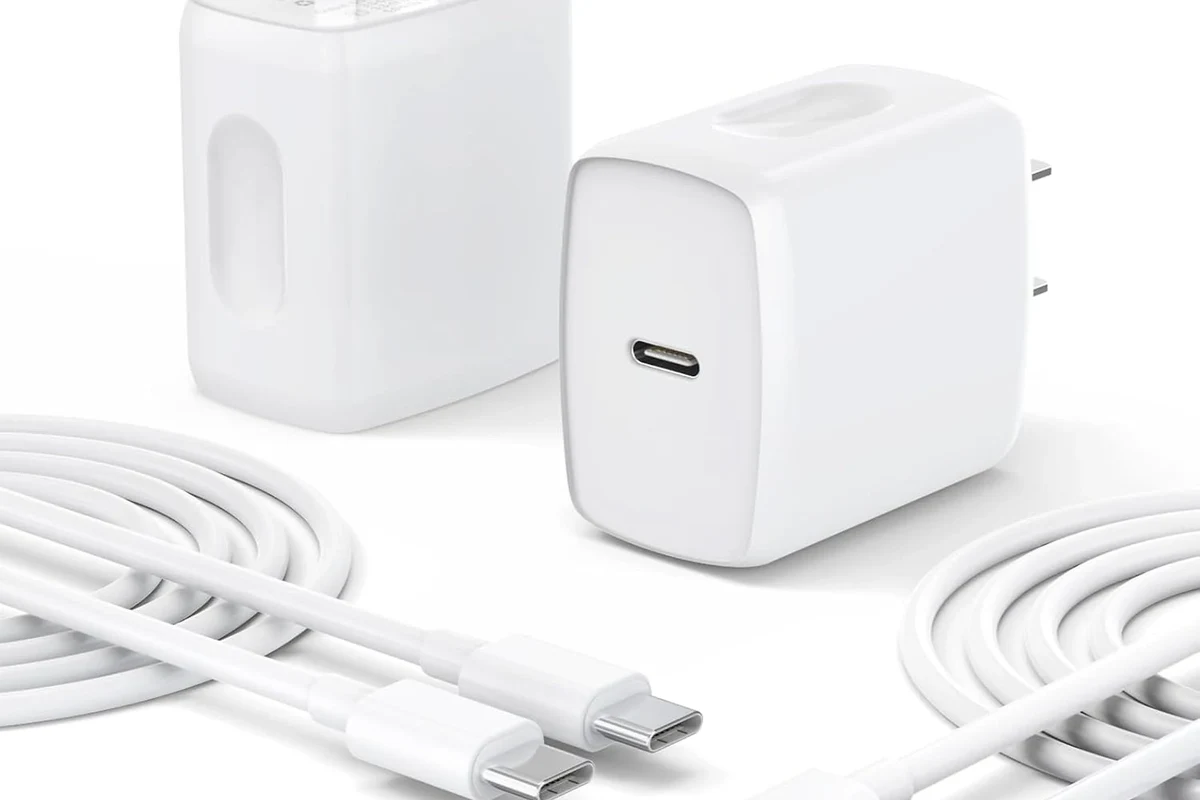 USB-C laptop charger connected to a modern notebook on a clean desk