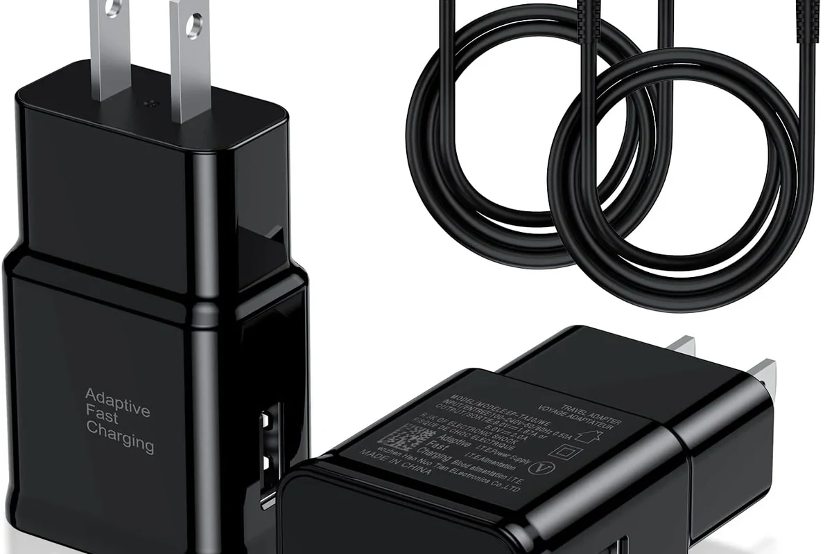USB-C cable with electronic marker chip concept beside charger and laptop